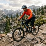 A rider on a 27.5 inch trail riding bike navigating rocky mountain terrain