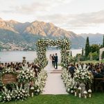 Elegant wedding reception tables decorated with fairy lights and green garlands.